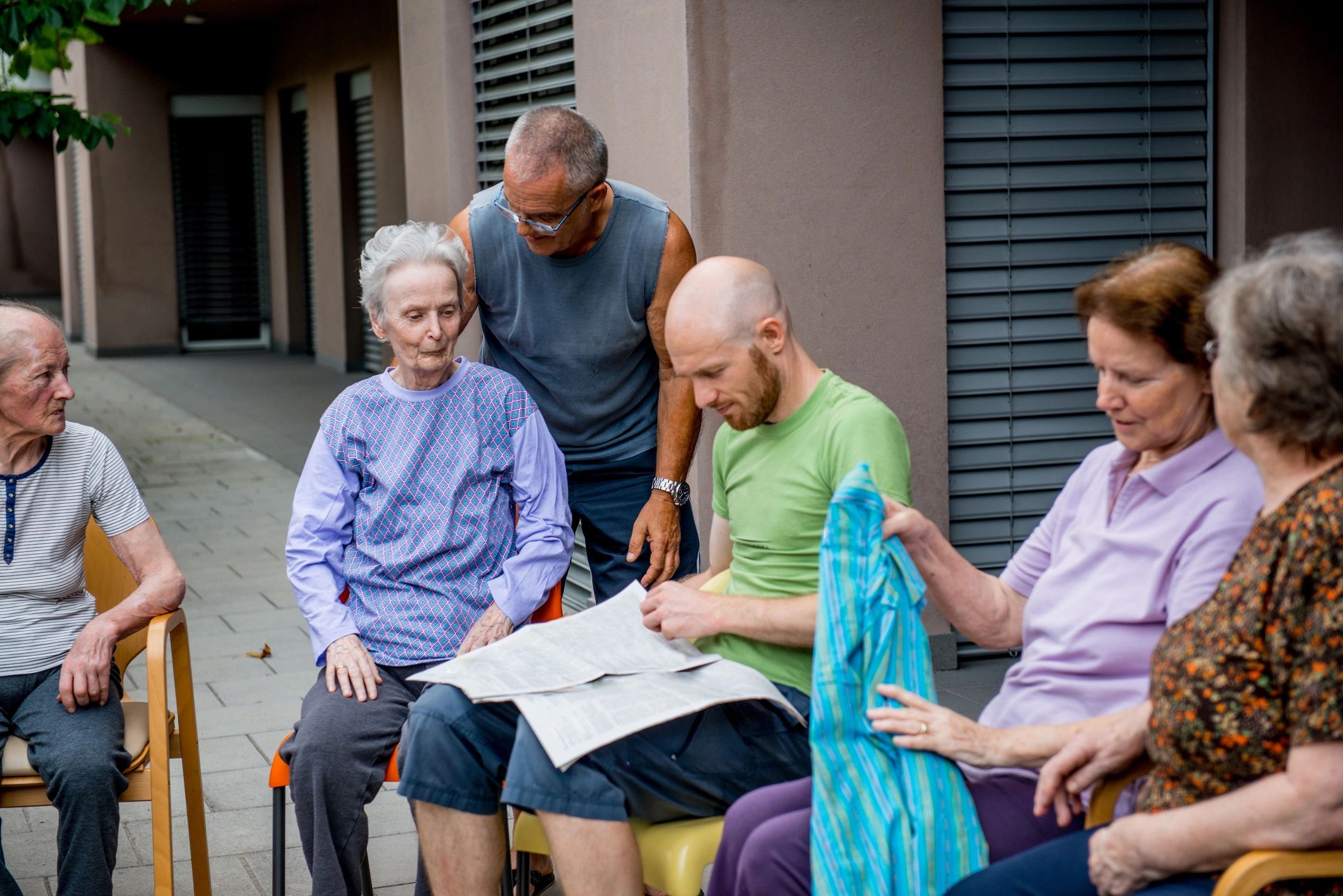 Residents reading community documents outdoors